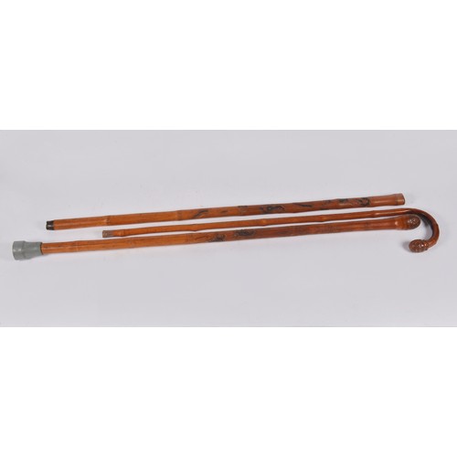 653 - Three Japanese Bamboo Walking sticks including two which are carved.