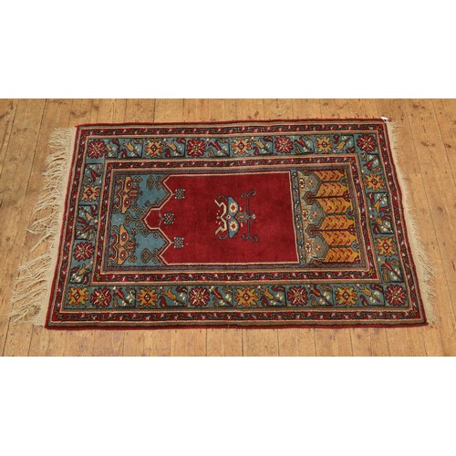 687 - A Blue & Red Ground Triple Bordered Prayer Rug decorated with Five Trident & Flamed Hook decoration.... 