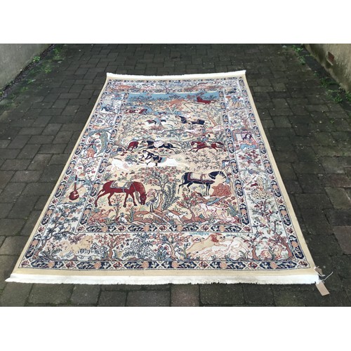 700 - A Turkistan Rug decorated with Hunting Scenes to include Lions, Tigers, Riders on Horseback containe... 