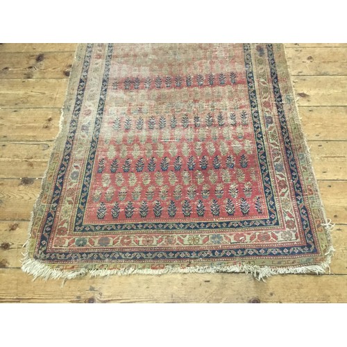 702 - An Antique Hand Made Persian Runner in Poor Condition. Measuring: 381cms x 101cms.