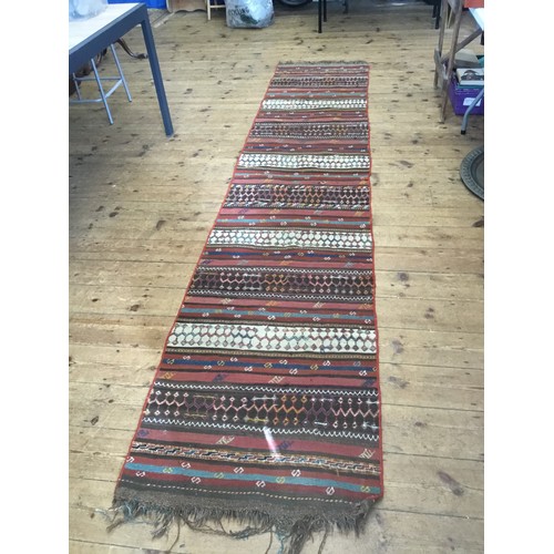 703 - A Turkish Kilim Runner. Measuring: 370cms x 73cms.