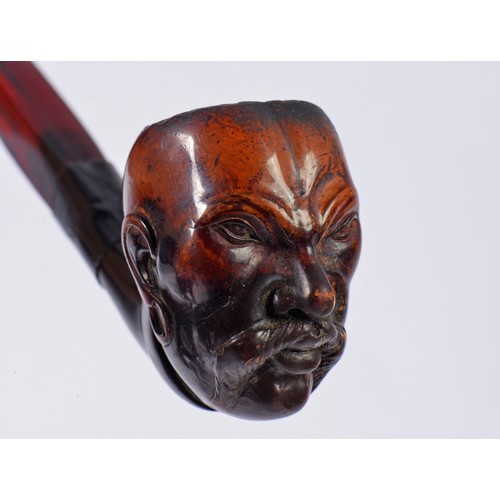 830 - A Meerschaum Pipe carved with a Chinese Head with a menacing Looking Face.