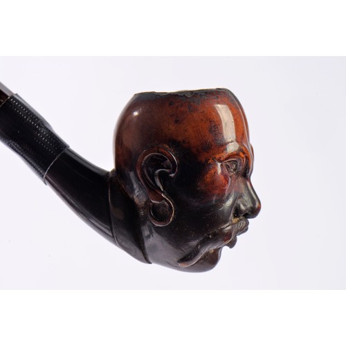 830 - A Meerschaum Pipe carved with a Chinese Head with a menacing Looking Face.