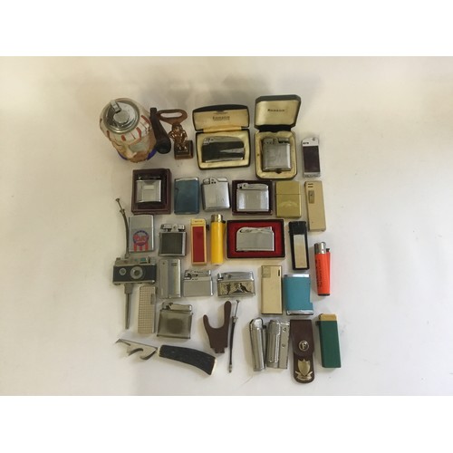 831 - A Collection of Lighters to include Ronson, Mosda, Pirate, Bebe, Camera on Stand, etc.