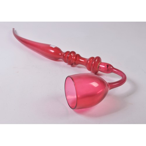 951 - A Late 19th Century Cranberry Glass Ruby tinted Apprentice Glass Makers Pipe. Measuring: 70cms Long.