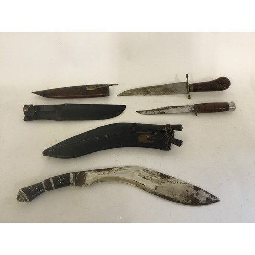 503 - A Kukri Knife in Hunting Case, an Ariel Hunting Knife in Scabbard & a Malaysian Knife in a Carved Ca... 