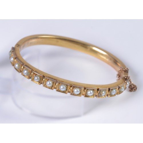 15 - A Ladies 15ct marked Gold & Pearl mounted Bangle with safety chain. Weighing: 20.6 grams.