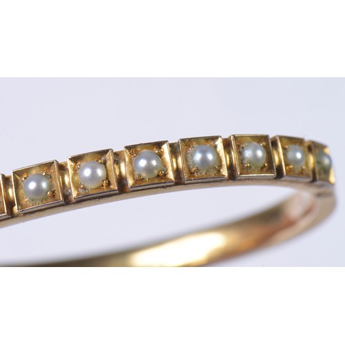 15 - A Ladies 15ct marked Gold & Pearl mounted Bangle with safety chain. Weighing: 20.6 grams.