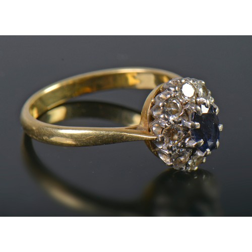 24 - A Ladies Sapphire & Diamond Dress Ring set with a cluster of Nine Diamonds. Size: O. Weighing: 4 gra... 