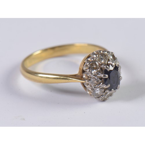 24 - A Ladies Sapphire & Diamond Dress Ring set with a cluster of Nine Diamonds. Size: O. Weighing: 4 gra... 