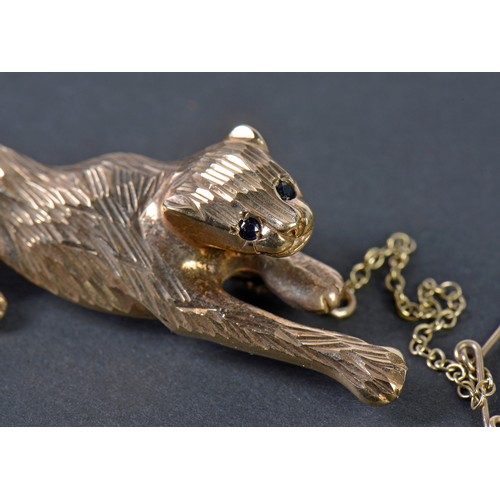 42 - A 9ct Gold Chiseled & Cut Panther Brooch with inset stones on safety chain. Weighing: 6.9 grams.