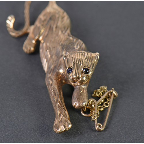 42 - A 9ct Gold Chiseled & Cut Panther Brooch with inset stones on safety chain. Weighing: 6.9 grams.