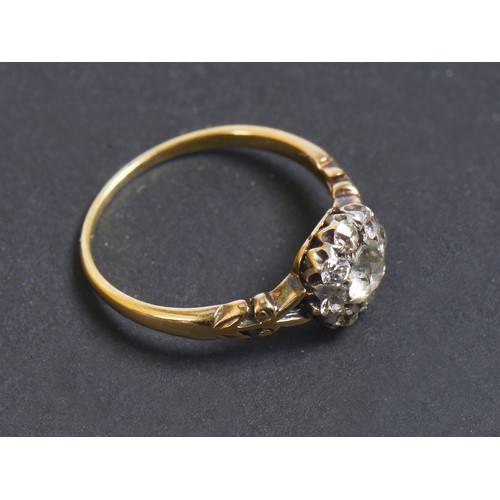 48 - A Ladies Diamond Cluster Ring set with a Central Stone & Eight Diamonds on a Pierced Open Work setti... 