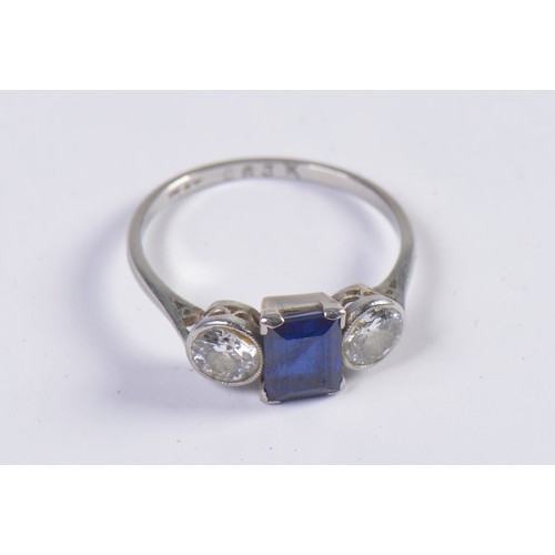 57 - A Ladies Sapphire & Diamond Dress Ring set with an Emerald Cut Dark Blue Sapphire & Two Diamonds. Si... 