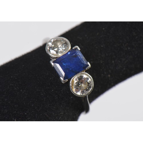 57 - A Ladies Sapphire & Diamond Dress Ring set with an Emerald Cut Dark Blue Sapphire & Two Diamonds. Si... 