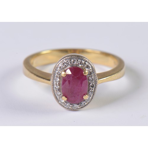 76 - A Modern 18ct Gold (Hallmarked) Cluster Ring set with an Oval Cut Ruby & Diamond edge. Size: L. Weig... 