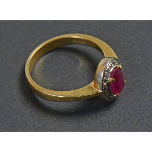 76 - A Modern 18ct Gold (Hallmarked) Cluster Ring set with an Oval Cut Ruby & Diamond edge. Size: L. Weig... 