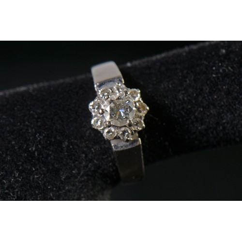 82 - A White Gold Diamond Cluster Ring set with a Central Stone & Nine Diamonds. Size: L. Weighing: 5.4 g... 