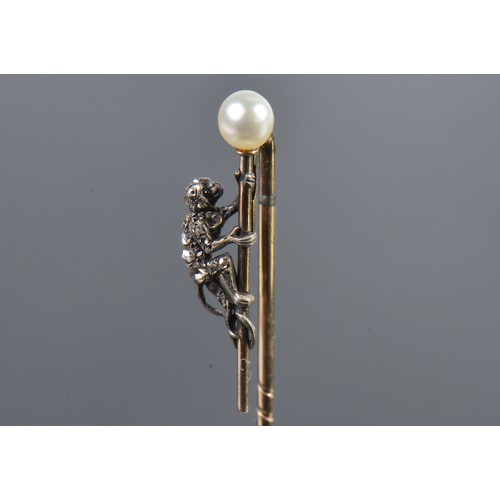 93 - A Monkey Diamond set Stick Pin mounted with a Pearl.