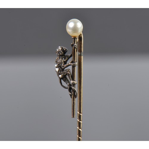 93 - A Monkey Diamond set Stick Pin mounted with a Pearl.