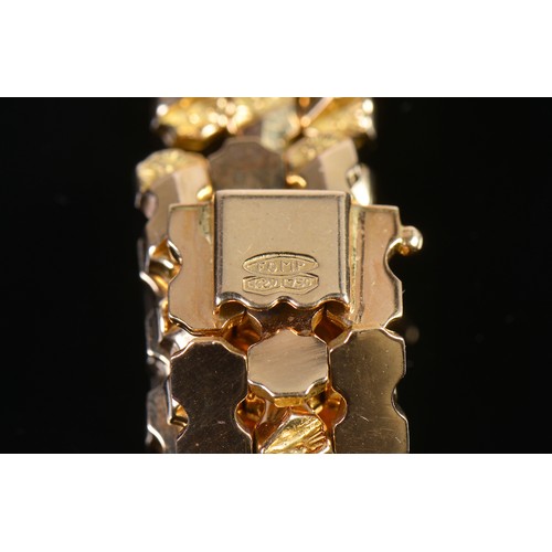 99 - A Ladies 18ct Gold Flexible Link Faceted & Floral Cut Bracelet. Weighing: 32 grams.