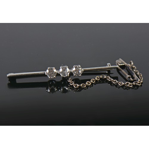 101 - A Ladies Three Stone Diamond Set Bar Brooch with safety chain.