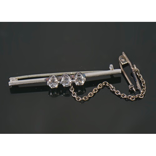 101 - A Ladies Three Stone Diamond Set Bar Brooch with safety chain.