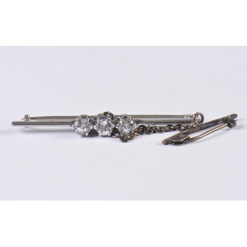 101 - A Ladies Three Stone Diamond Set Bar Brooch with safety chain.