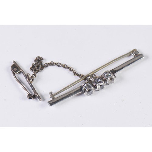 101 - A Ladies Three Stone Diamond Set Bar Brooch with safety chain.