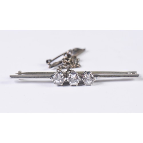 101 - A Ladies Three Stone Diamond Set Bar Brooch with safety chain.