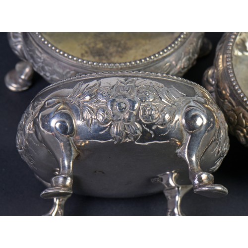 189 - A Set of Three Georgian Silver Rococo pattern Salt Cellars, London Q. Maker: (Rubbed). Weighing: 345... 