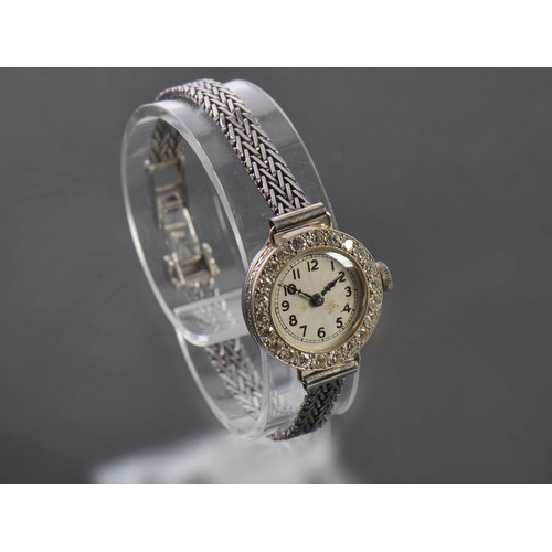 229 - A Ladies 9ct White Gold Cocktail Watch set with approximately 23 Diamonds. Weighing: 13.2 grams.