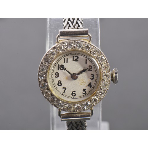 229 - A Ladies 9ct White Gold Cocktail Watch set with approximately 23 Diamonds. Weighing: 13.2 grams.