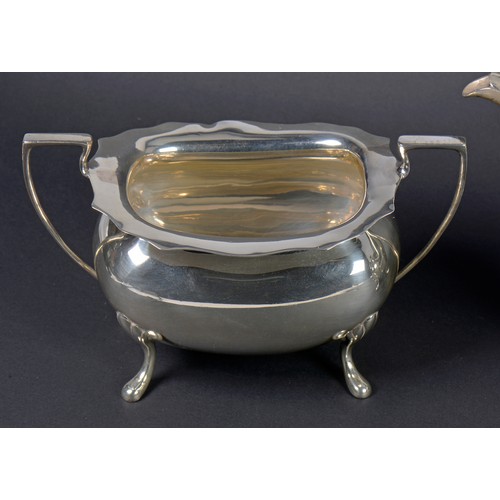 15 - A Three Piece Georgian design Silver Tea Set with a Chippendale Border & resting on Pad Feet. Sheffi... 