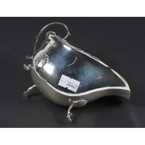 56 - A Silver Scroll bordered Sauce Boat. Weighing: 79 grams.