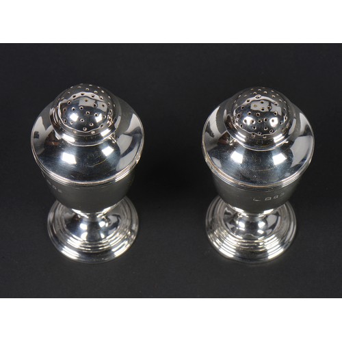 57 - A Pair of Silver Bun Top Pepper Castors on pedestal bases. London P. Weighing: 160 grams.