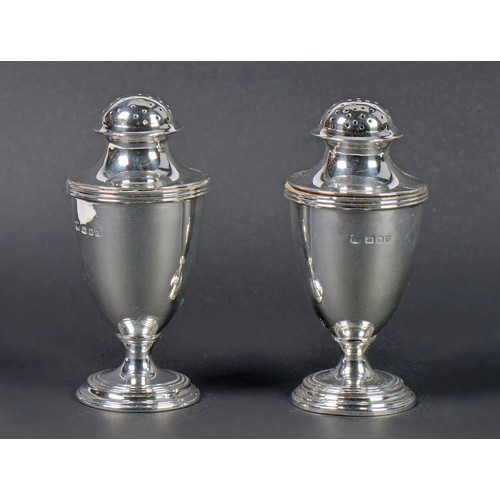 57 - A Pair of Silver Bun Top Pepper Castors on pedestal bases. London P. Weighing: 160 grams.