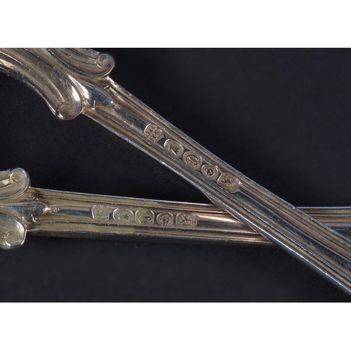 69 - A Pair of Silver Hourglass & Husk Reeded Table Spoons. London D. Weighing: 239 grams..