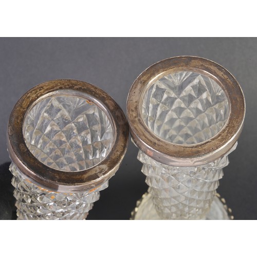 84 - A Pair of Silver mounted Cut Glass Specimen Vases with Diamond Point Cutting. Measuring: 23cms high.