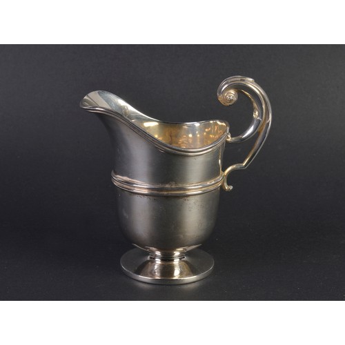 89 - A Silver Helmet shaped Cream Jug with a Flying Scroll Handle. London G. Weighing: 106 grams.