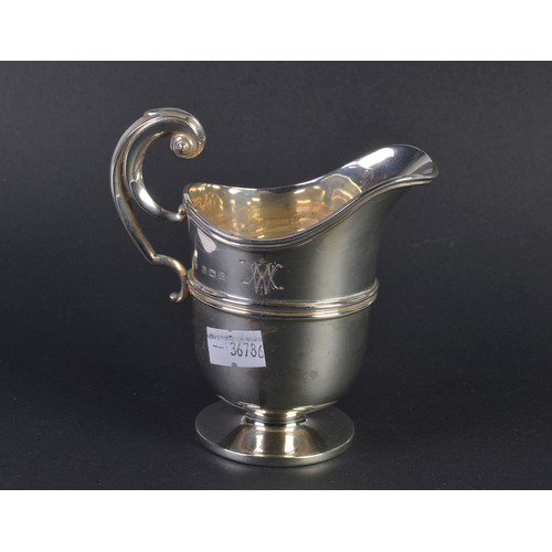 89 - A Silver Helmet shaped Cream Jug with a Flying Scroll Handle. London G. Weighing: 106 grams.