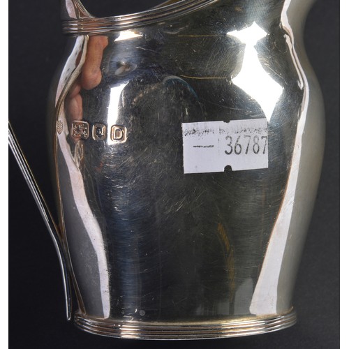 90 - A Georgian designed Cream Jug with a reeded handle. Weighing: 138 grams.