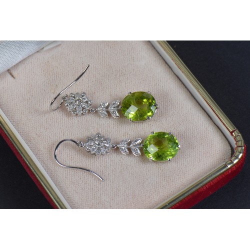 163 - A Pair of 585 marked Diamond & Green Stone Long Drop Earrings.