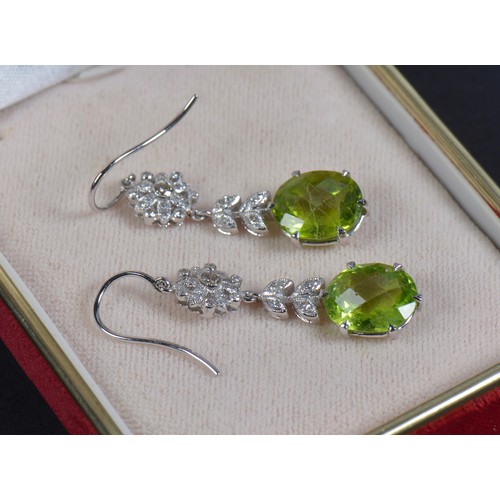 163 - A Pair of 585 marked Diamond & Green Stone Long Drop Earrings.