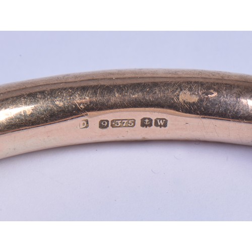 240 - A Ladies 9ct Gold Slave Bangle. Weighing: 16.9 grams. Measuring: 8cms opening.