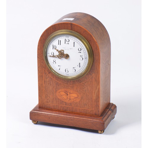 321 - A Satin Wood inlaid Drawing Room Clock with a domed top & a French movement. Measuring: 21cms High.