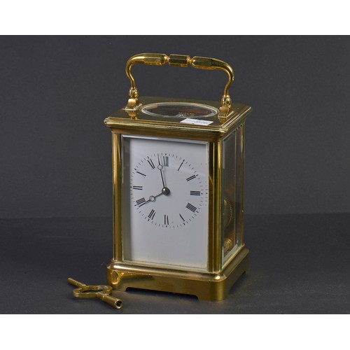 324 - A French Brass Four Plate Carriage Clock with visible escapement, Roman Numerals & Striking Complete... 