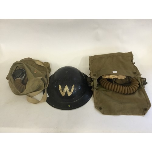 563 - A Warden's WWII Black painted Tin Helmet & Two Gas Mask's in there Original Canvas Bags.