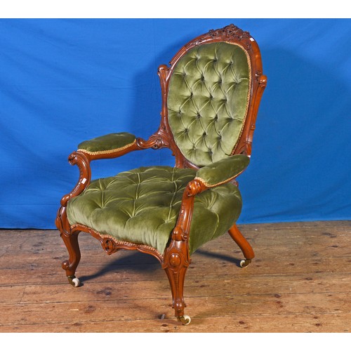 670 - A Victorian Walnut Framed Heavily Carved Rolling Scroll & Carved Cresting Elbow Chair in a Green Dra... 