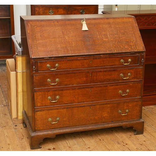 673 - A Georgian Oak & Banded Bureau fitted with Four graduated Drawers, Slides, Fitted interior, Pigeon H... 